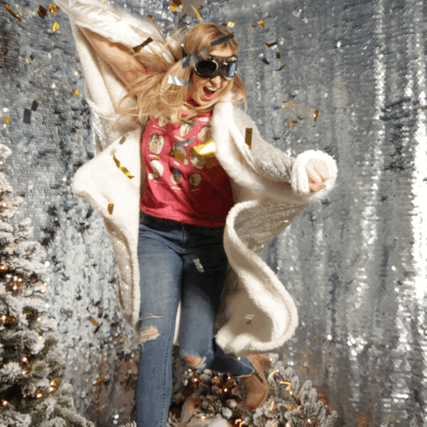 A woman jumps and is frozen in a 3D Animated GIFe as confetti floats around her