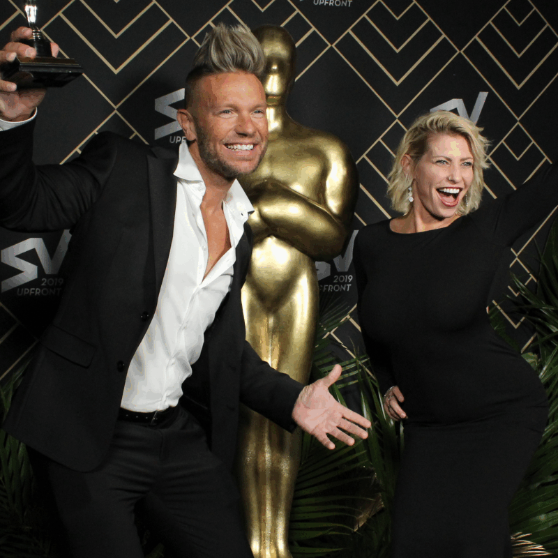 Time Slice image of couple posing with a Screen Vision award