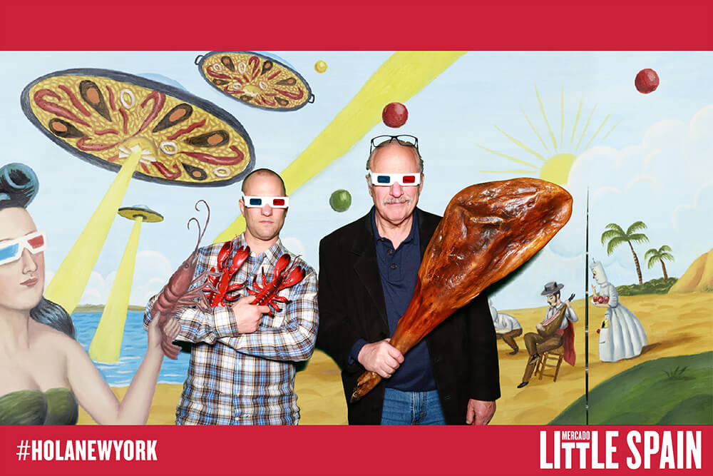 Green Screen Photo Booth Two men pose with meat props in front of a green screen