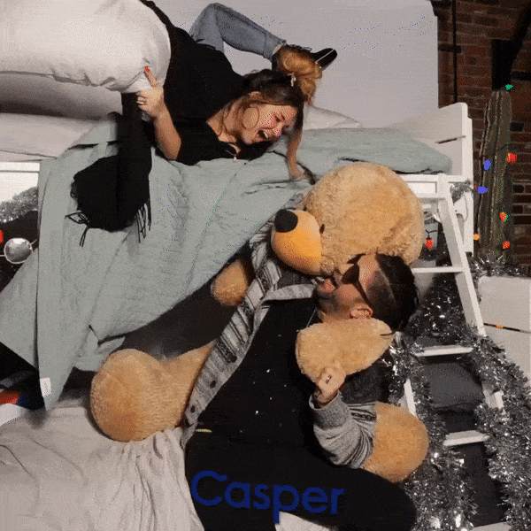 A camera array GIF with a woman and man on a bunk bed and having a pillow fight.
